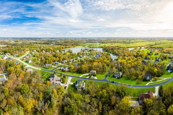 Aerial footage of residential subdivision by a lake in Central Kentucky in fall